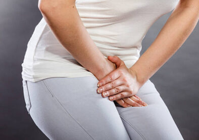 Young sick woman with hands holding pressing her crotch lower abdomen. Medical or gynecological problems, healthcare concept